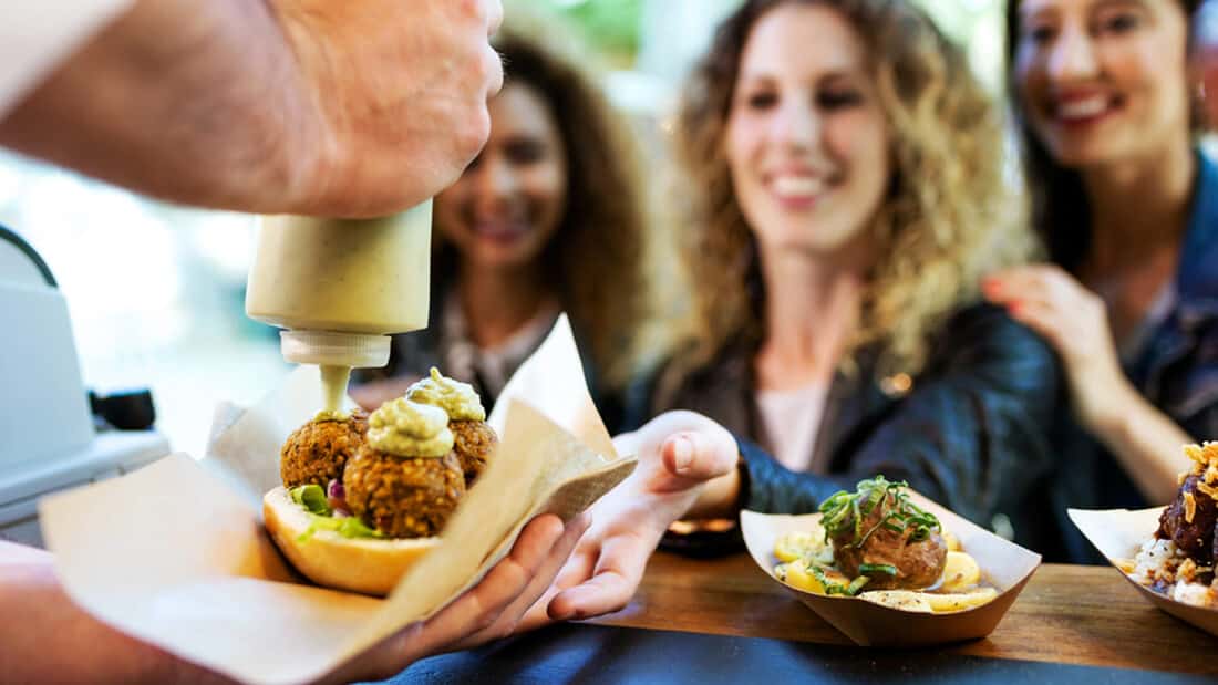 Young women buying from a food truck